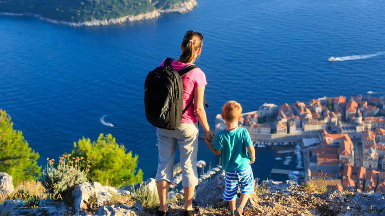 Family overlooking Dubrovnik's historic old town and the Adriatic Sea in Croatia.